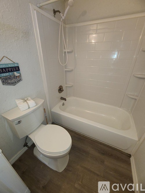 A yellow house with a white fence in front.