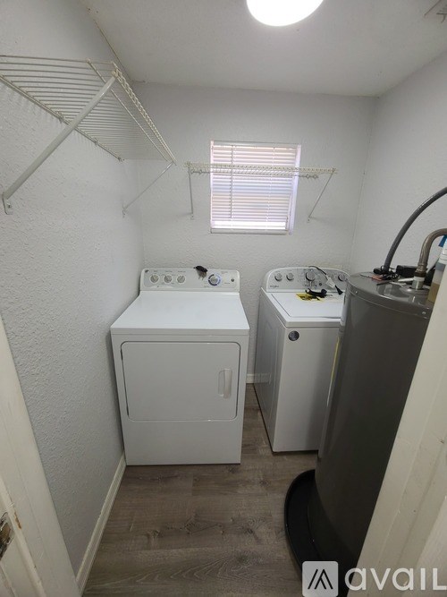 A small laundry room with a washer and dryer.