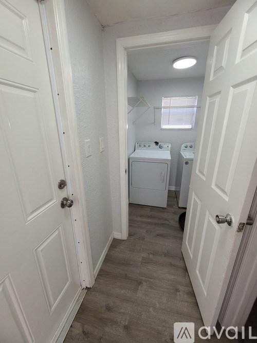 A small laundry room with a washer and dryer.