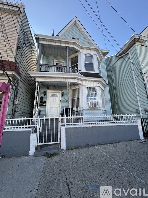 A house with a white door and a balcony with a railing.