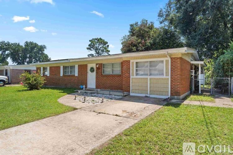 A red brick house with a white door and windows.