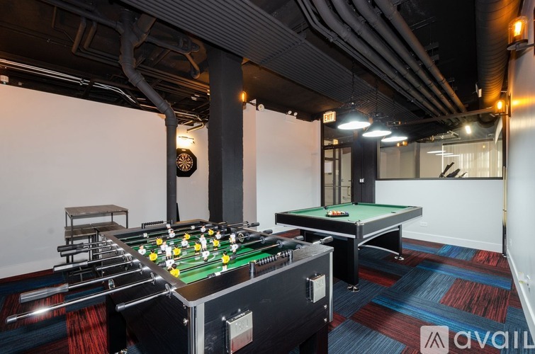 A pool table with a green felt cloth and white balls is in the foreground of the image.