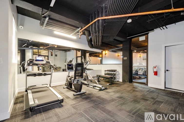 A gym with treadmills, exercise bikes, and other equipment.