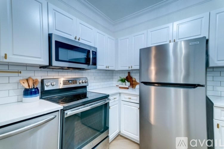 A room with wooden floors and a chandelier hanging from the ceiling.