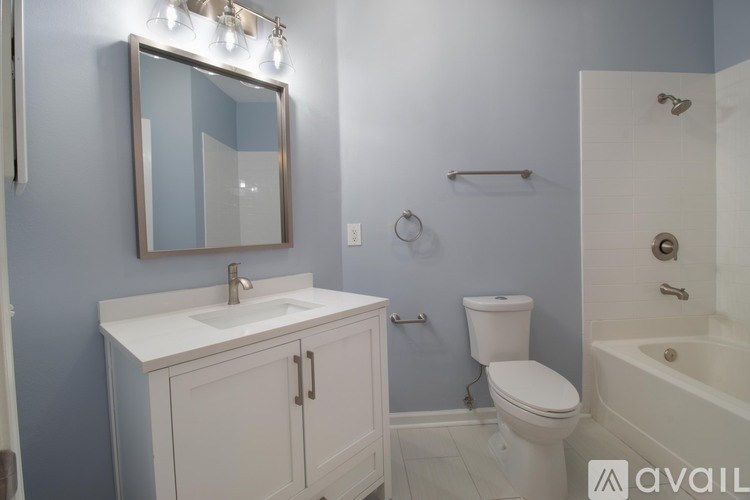 A bathroom with a white sink and a white toilet.
