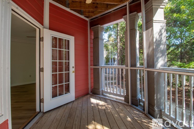 A red house with a white door and a balcony.