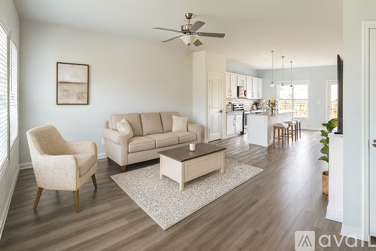 A living room with a beige sofa, a chair, and a coffee table.