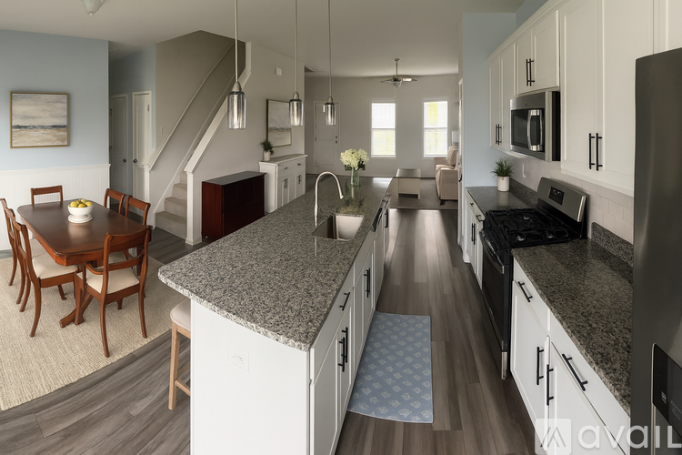 A kitchen with a dining table and chairs.