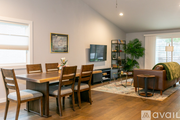 A dining room with a wooden table and chairs.