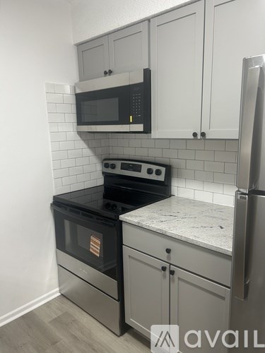 A kitchen with a black oven and microwave above a black stove.