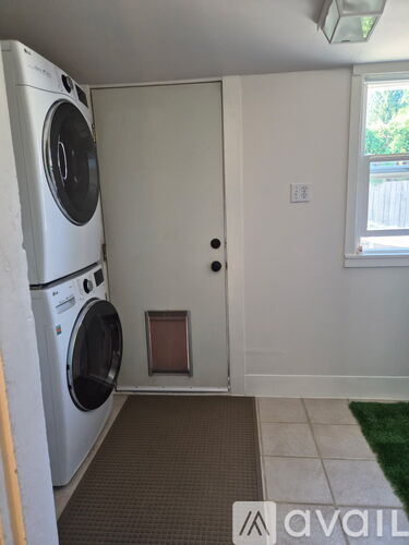 A small laundry room with a washer and dryer.