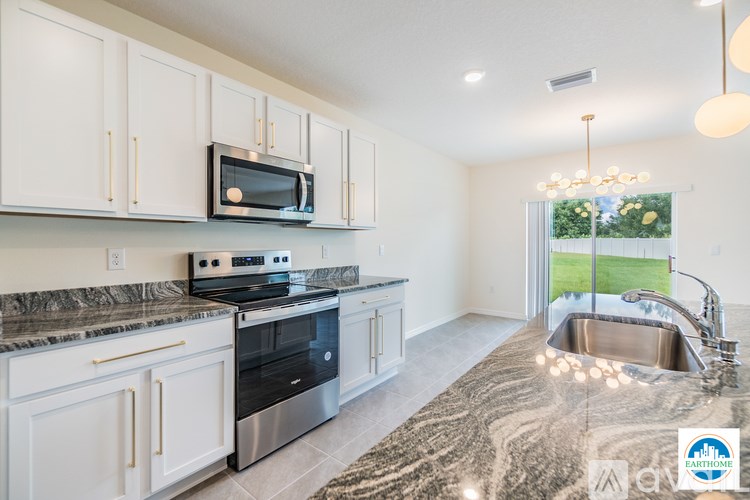 A kitchen with granite countertops and stainless steel appliances.