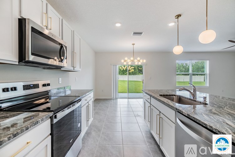 A kitchen with a black stove top oven and a black microwave.