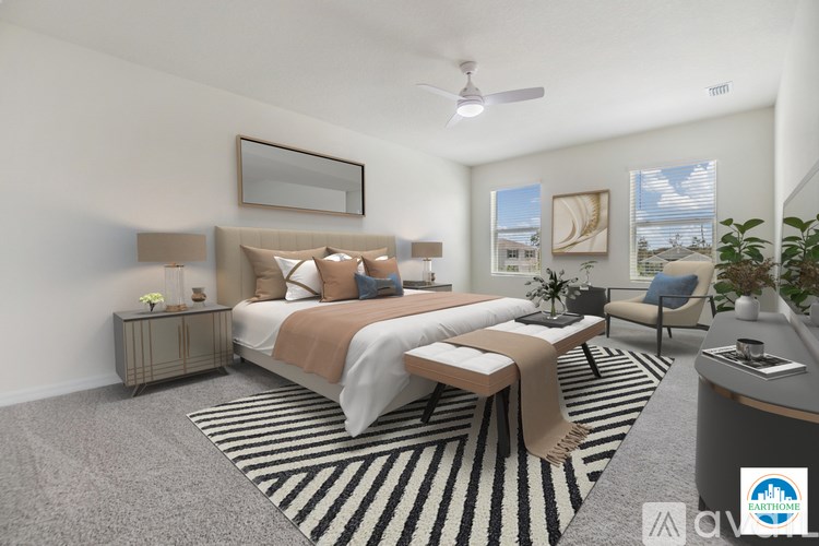 A bedroom with a large bed and a striped rug.