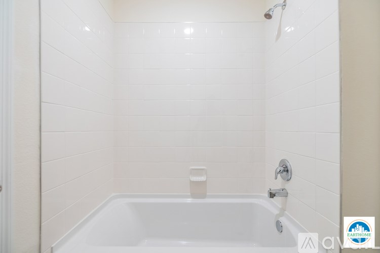 A white bathroom with a tub and shower.