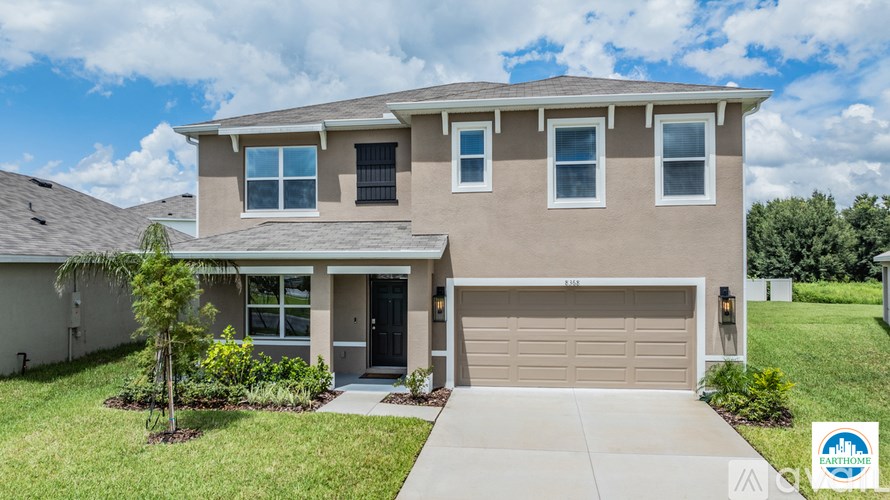 A house with a brown garage door and a driveway.