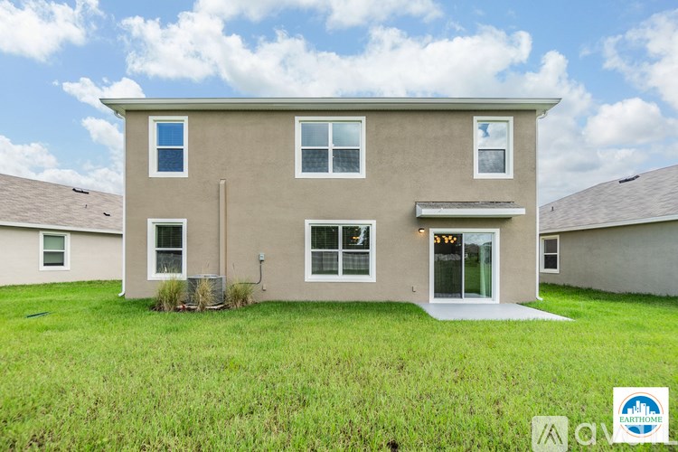 A two-story house with a front yard and a garage.