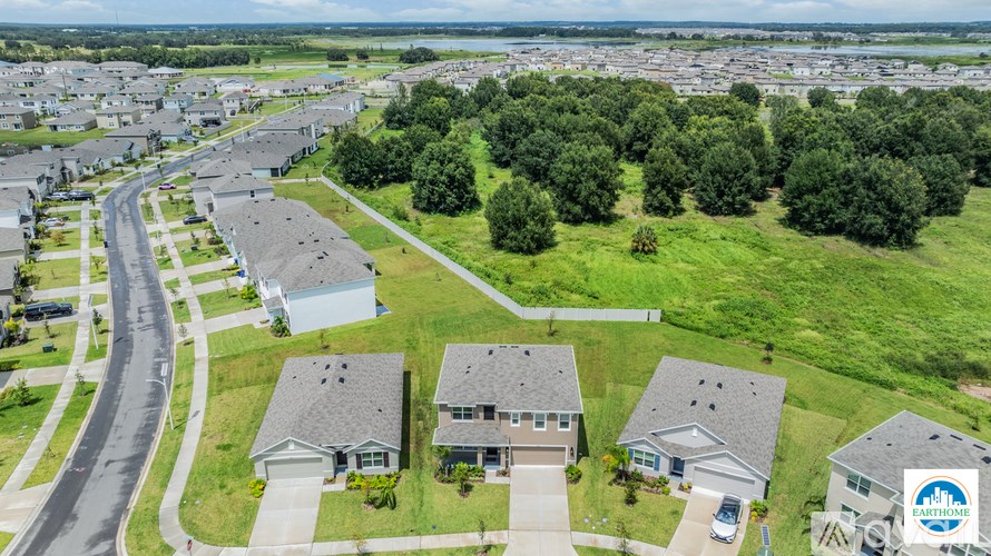 A bird's eye view of a residential area with houses and a road.