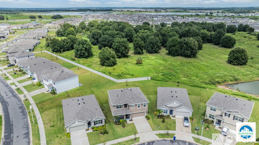 A bird's eye view of a suburban neighborhood with houses and a road.