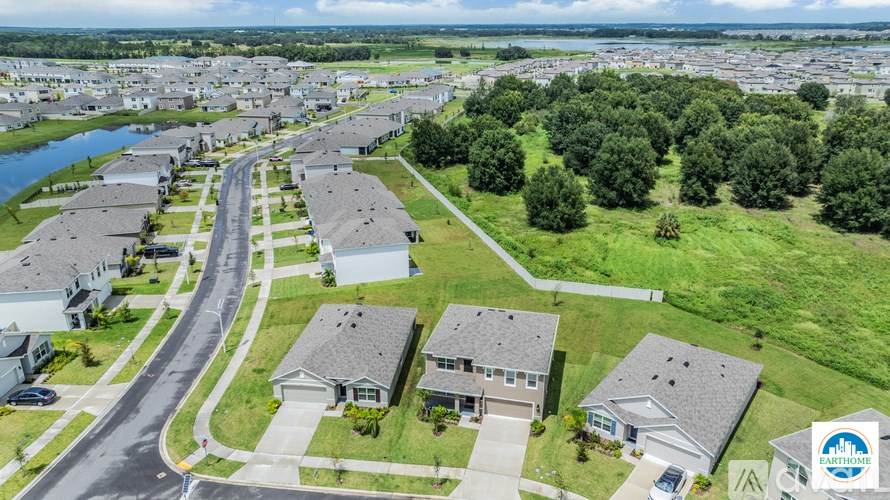 A bird's eye view of a residential area with houses and a river.