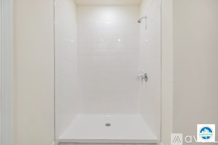 A white bathroom with a walk in shower.