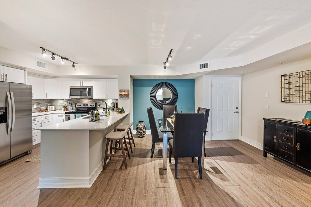 an open kitchen and dining area with a table and chairs