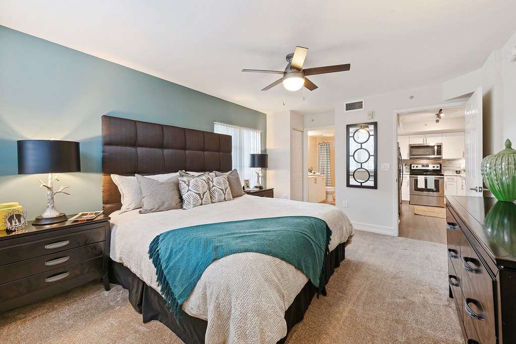 a bedroom with a large bed and a ceiling fan