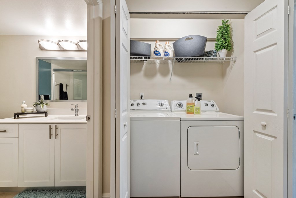 a laundry room with a washer and dryer and a sink