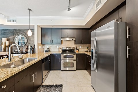 a kitchen with stainless steel appliances and granite counter tops