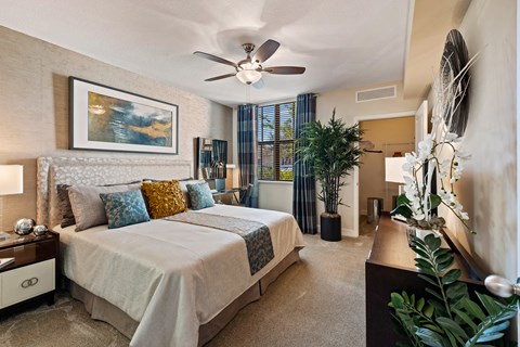 a bedroom with a bed and a ceiling fan