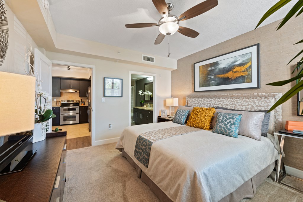 a bedroom with a large bed and a ceiling fan
