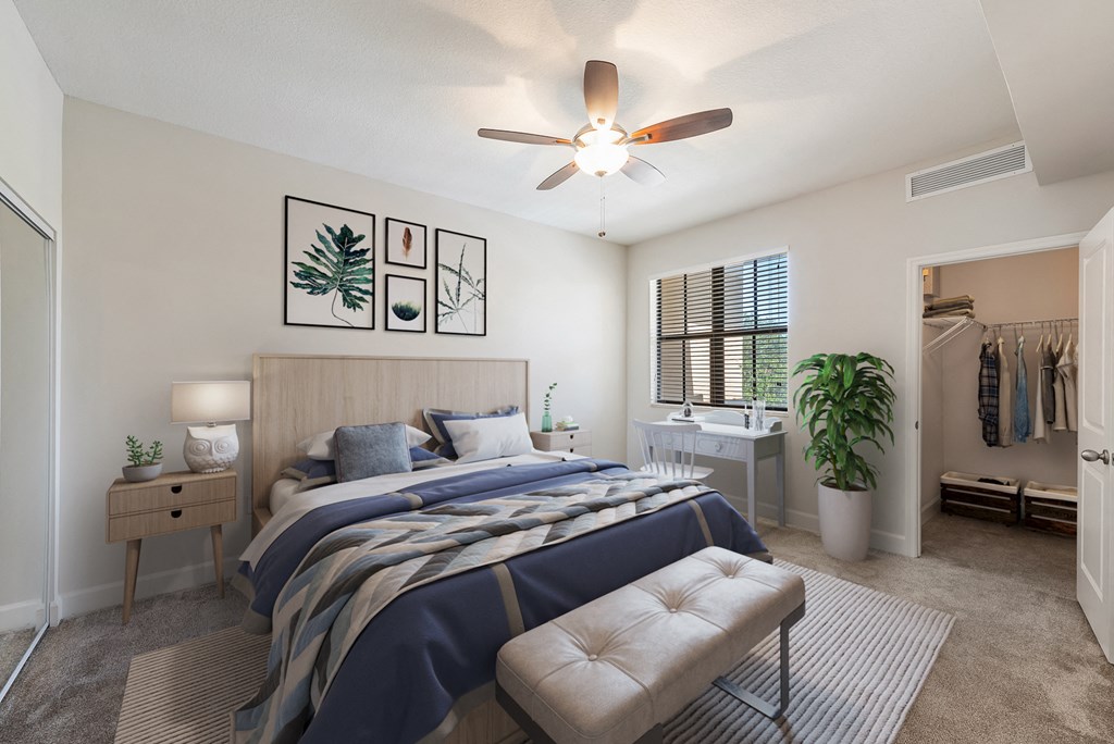 a bedroom with a large bed and a ceiling fan