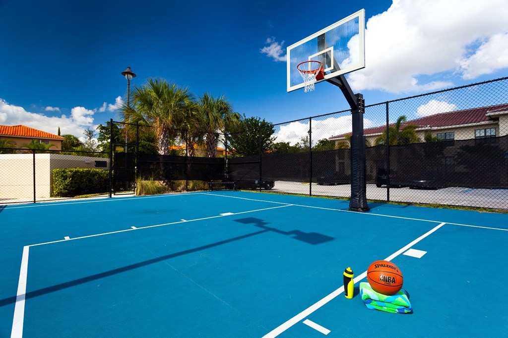 a tennis court with a basketball hoop and a ball on it