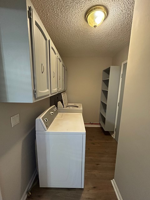 A white washing machine in a laundry room.