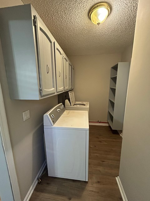 A small laundry room with a washer and dryer.