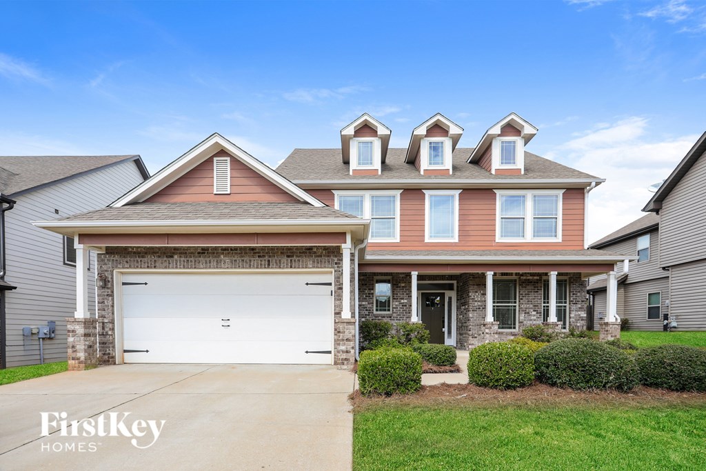A two-story house with a garage is for sale.