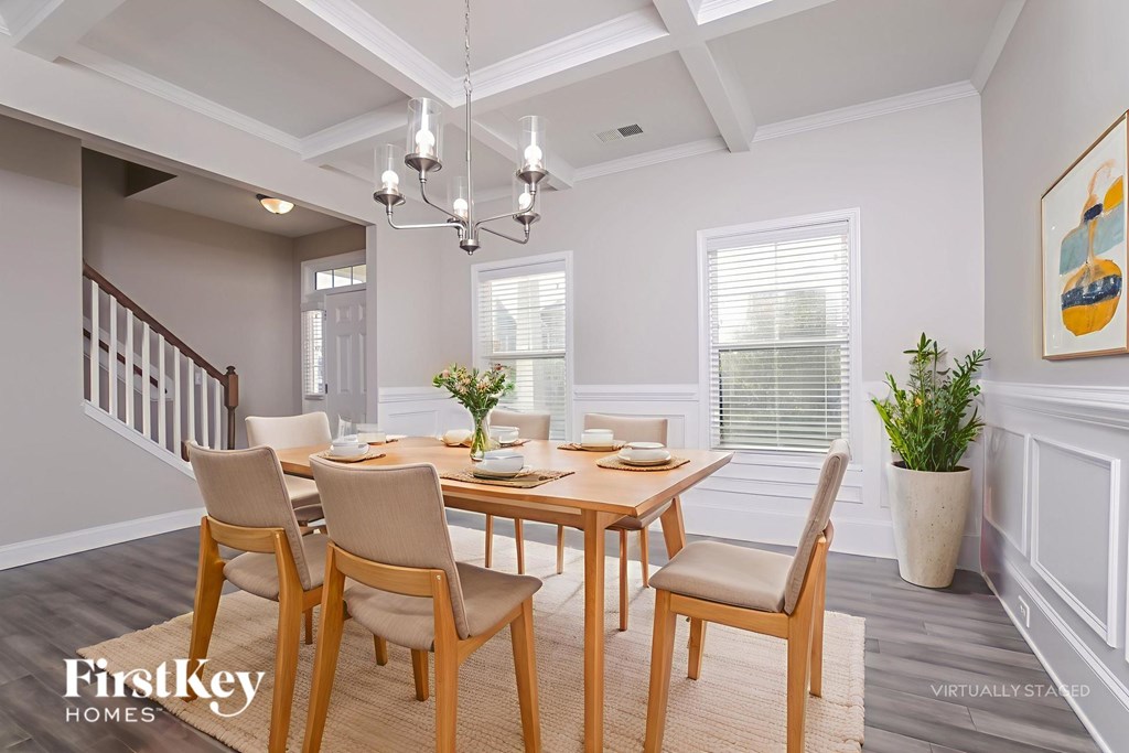 A dining room with a wooden table and chairs.