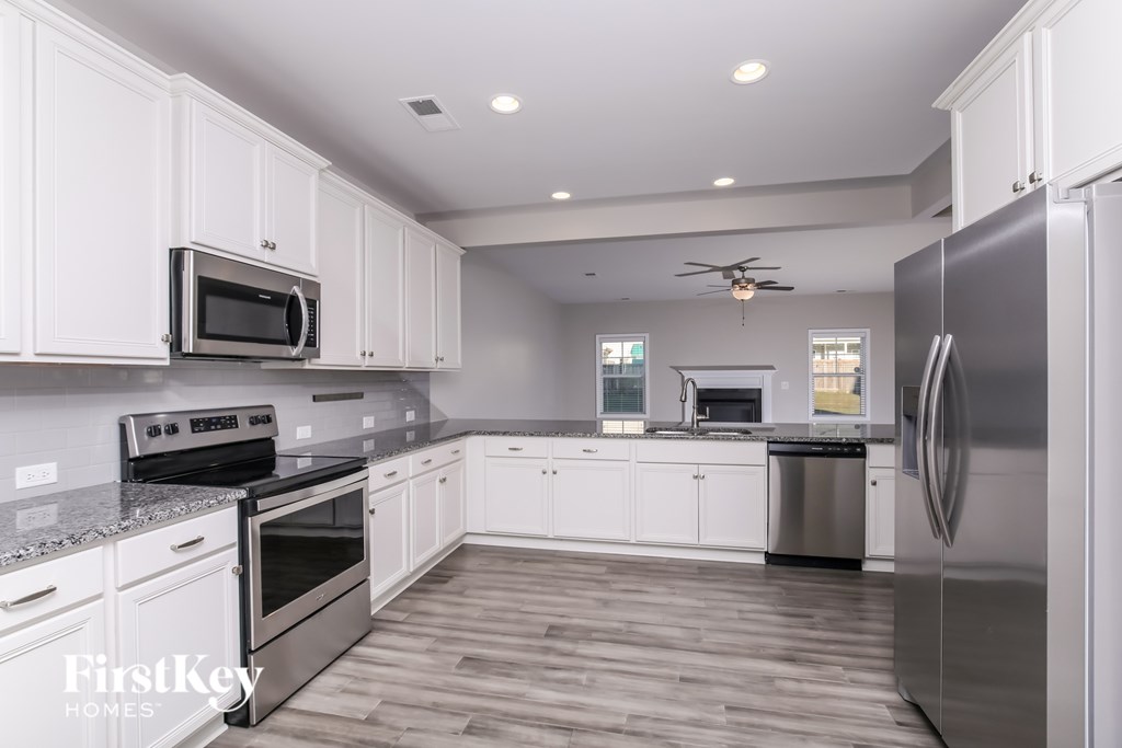 A kitchen with white cabinets and stainless steel appliances.