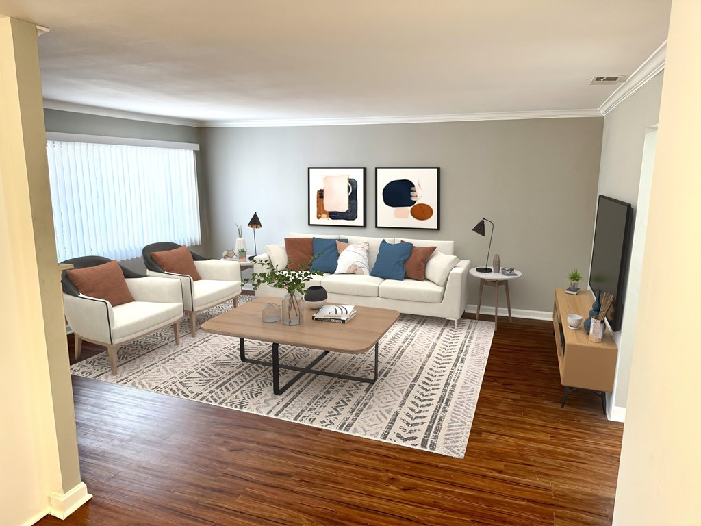 A living room with a white couch, a coffee table, and two chairs.
