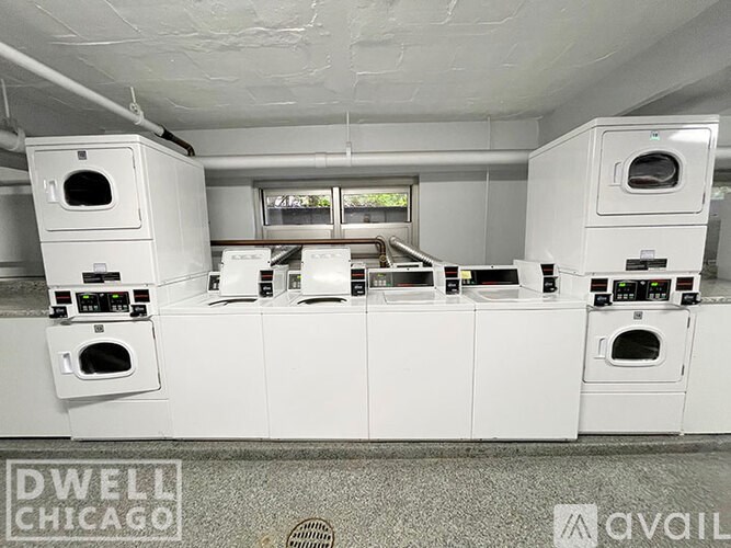A row of white ovens are lined up in a room.