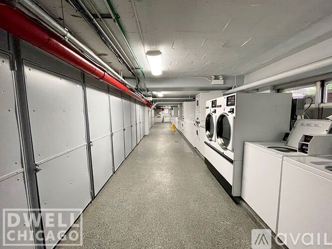 A long hallway with washing machines on both sides.