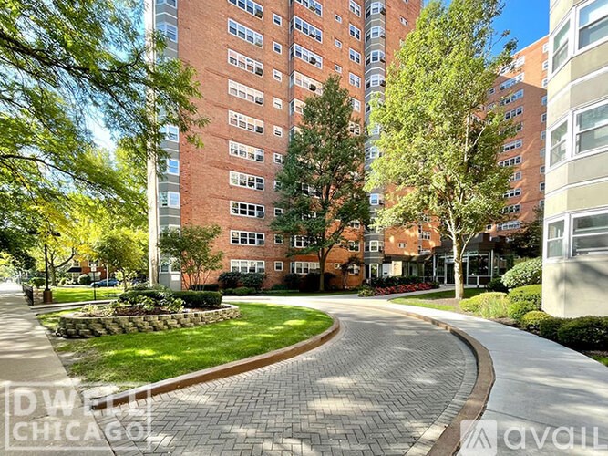 A brick building with a tree in front of it.