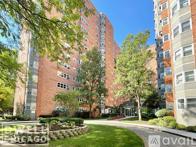 A large brick building with a green lawn in front.
