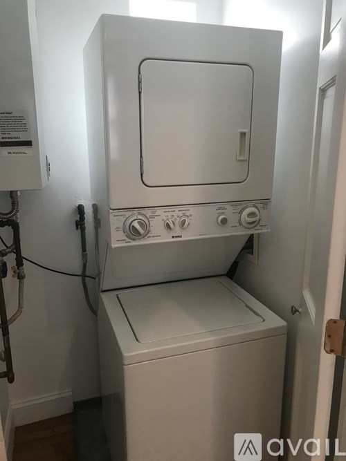 A white washing machine and dryer in a small laundry room.