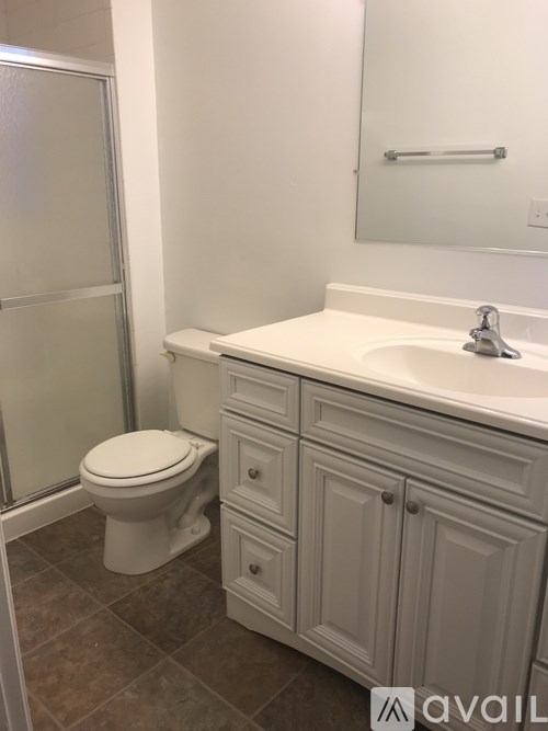 A white toilet sits next to a sink in a bathroom.