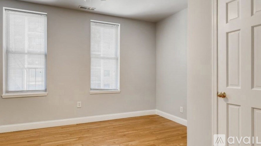 A room with wooden floors and a white door.