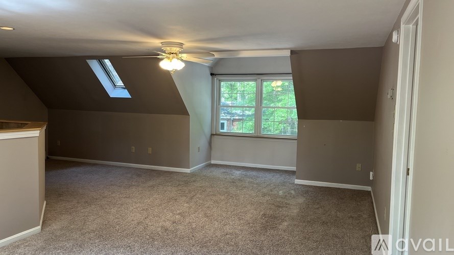 A room with a window and a ceiling fan.