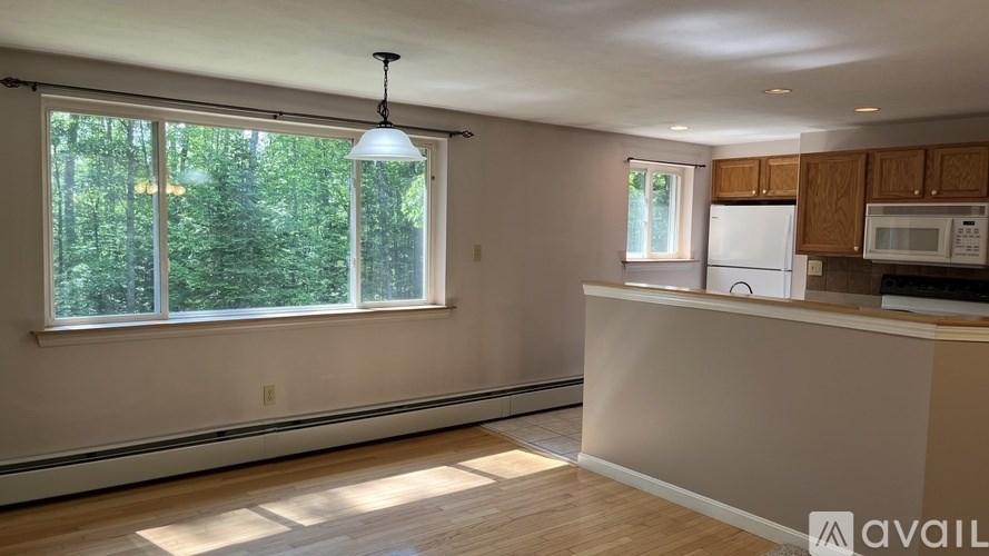 A kitchen with wooden cabinets and a white refrigerator.