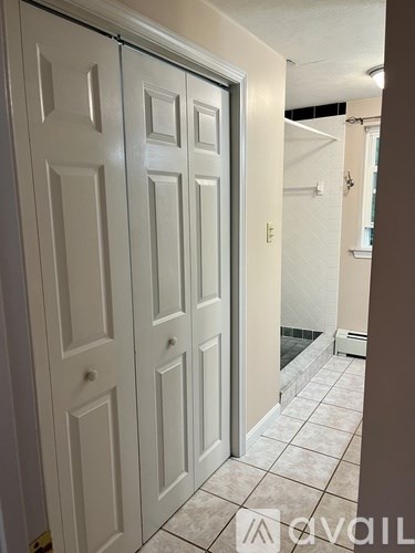 A white door with a glass panel is open.