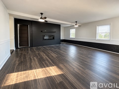 A modern kitchen with a stainless steel range hood above a window.